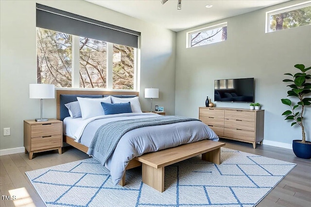 bedroom featuring light wood-type flooring and baseboards