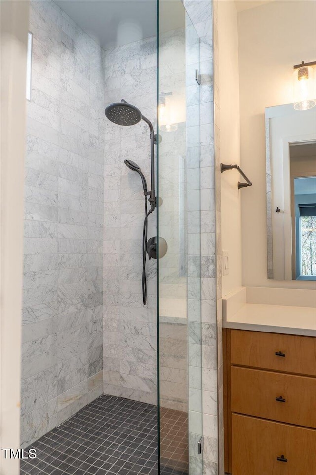 bathroom with a shower stall and vanity