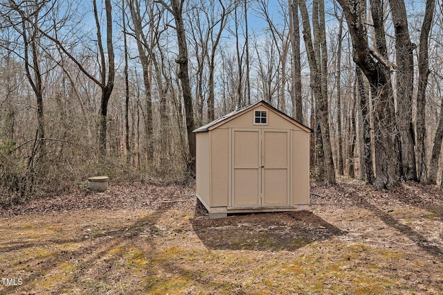 view of shed with a forest view