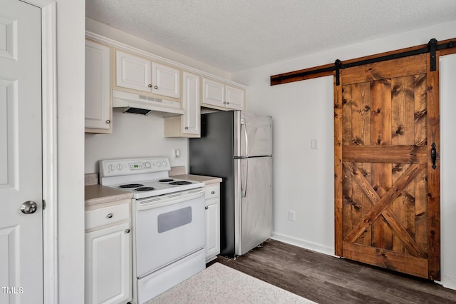 kitchen featuring a barn door, under cabinet range hood, freestanding refrigerator, white range with electric cooktop, and dark wood finished floors