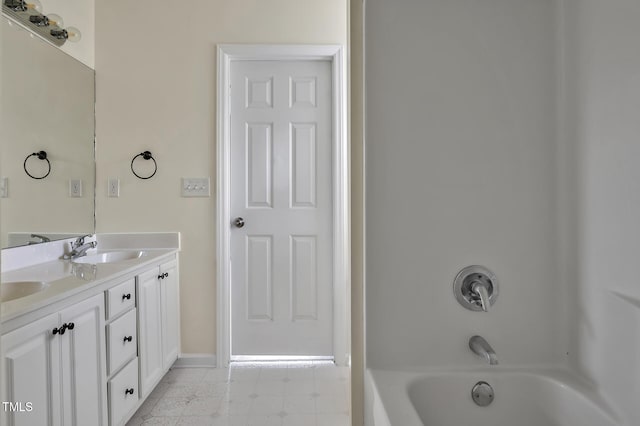 full bath with double vanity, baseboards,  shower combination, and a sink