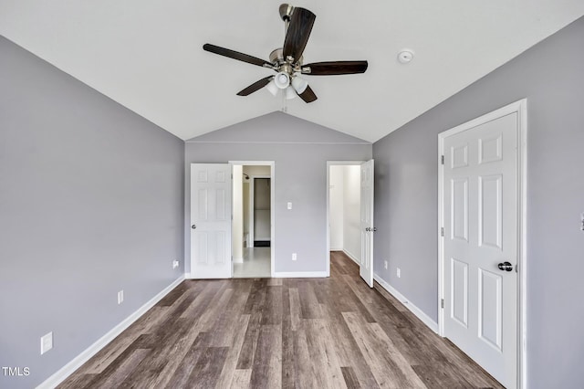 unfurnished bedroom featuring lofted ceiling, ceiling fan, baseboards, and wood finished floors