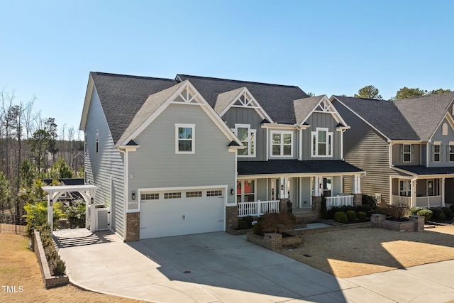 view of front of property with board and batten siding, covered porch, an attached garage, and concrete driveway