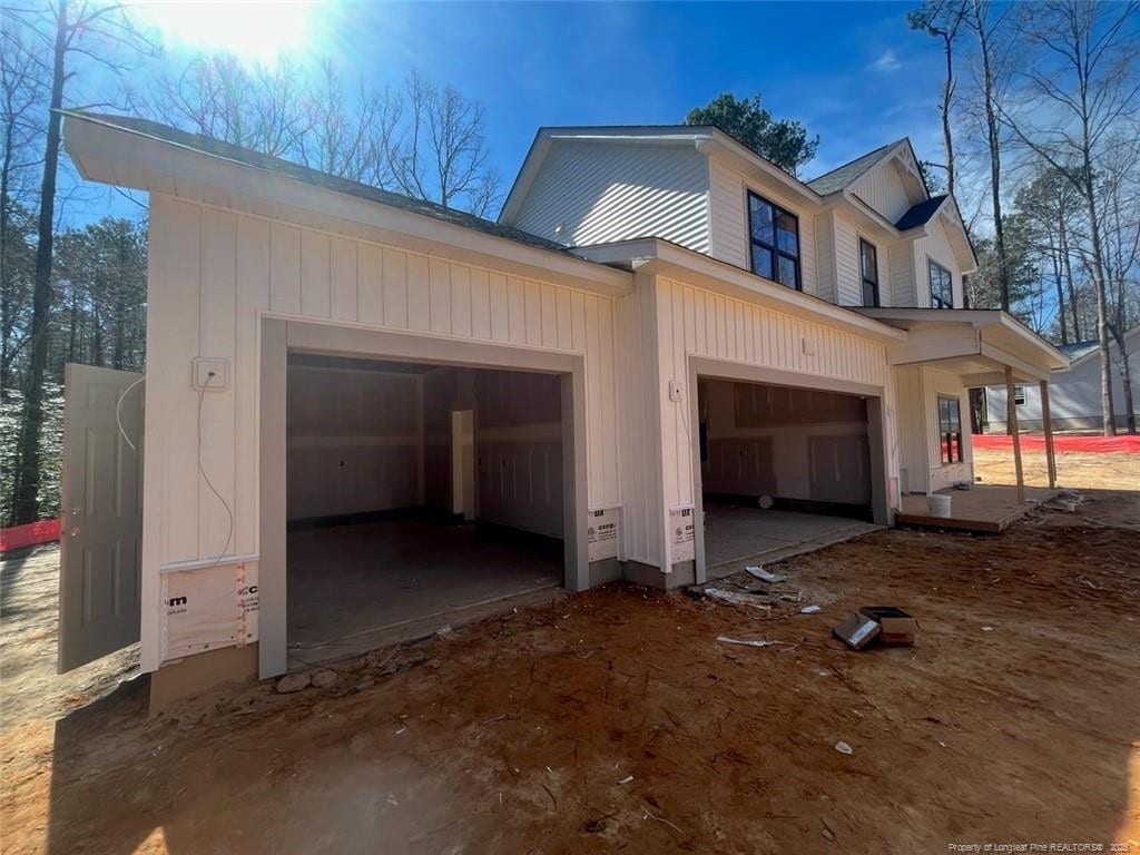 view of property exterior with dirt driveway