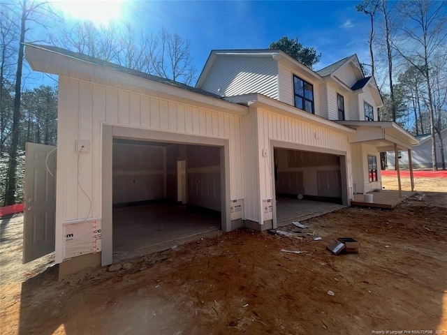 view of property exterior with dirt driveway