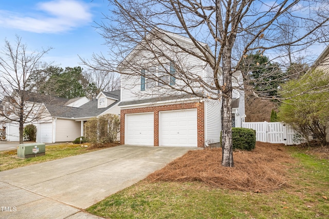 view of front of house with a garage, brick siding, concrete driveway, and fence