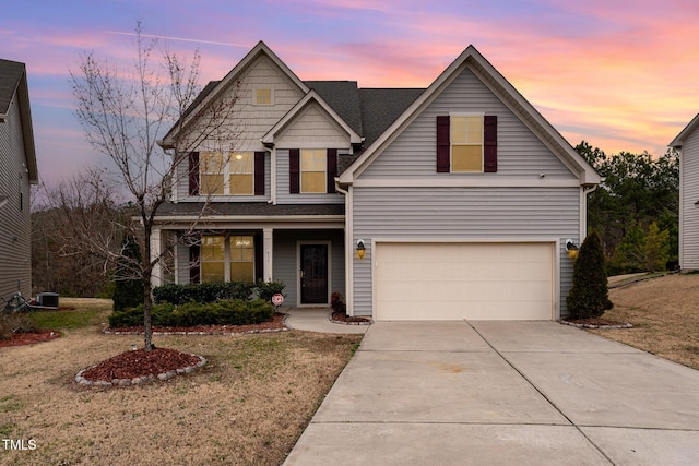 traditional-style home featuring concrete driveway, a front lawn, an attached garage, and central air condition unit