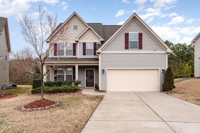 view of front of home with a garage, driveway, central AC unit, and a front yard