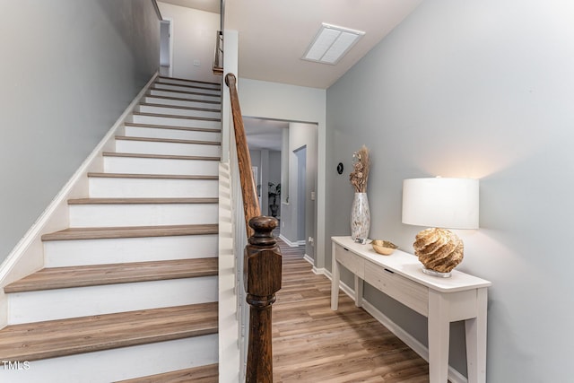 stairs with baseboards and wood finished floors