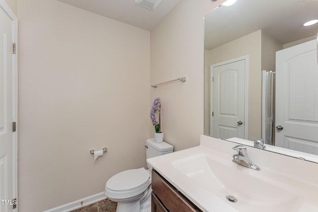 bathroom featuring visible vents, baseboards, vanity, and toilet