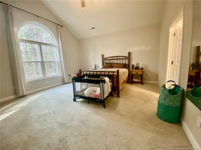 carpeted bedroom with visible vents, baseboards, and vaulted ceiling