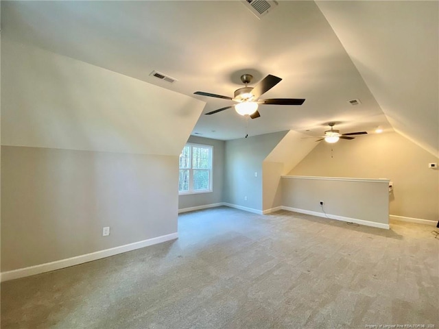 bonus room featuring lofted ceiling, visible vents, and baseboards