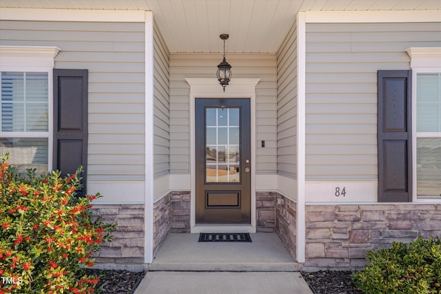 entrance to property with stone siding