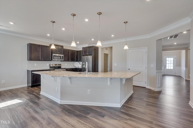 kitchen featuring dark brown cabinetry, stainless steel appliances, visible vents, dark wood finished floors, and crown molding