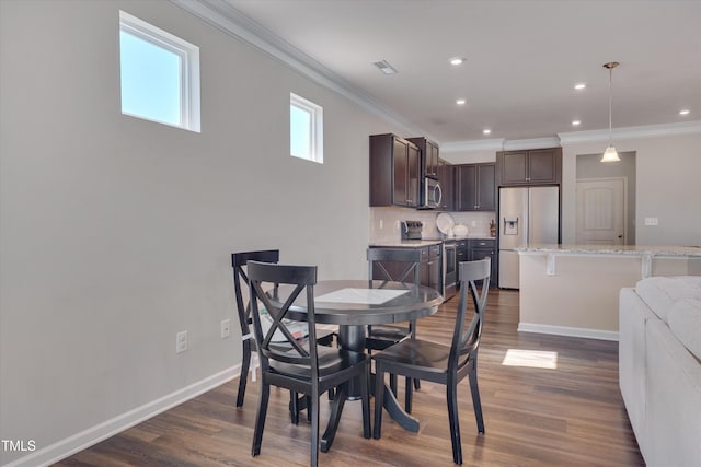 dining room with visible vents, baseboards, dark wood finished floors, crown molding, and recessed lighting