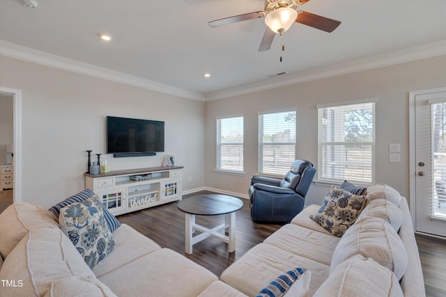 living room featuring a wealth of natural light, crown molding, visible vents, and wood finished floors