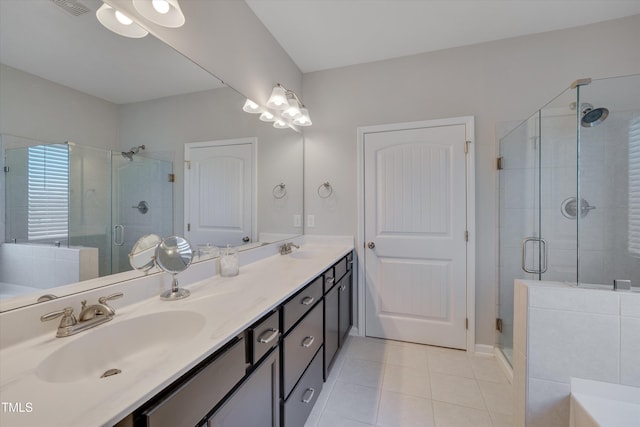 bathroom with double vanity, a stall shower, a sink, a tub, and tile patterned floors