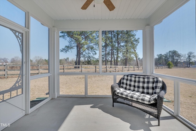 sunroom featuring a ceiling fan