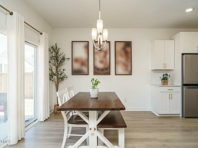 dining space featuring light wood finished floors, baseboards, a wealth of natural light, and recessed lighting