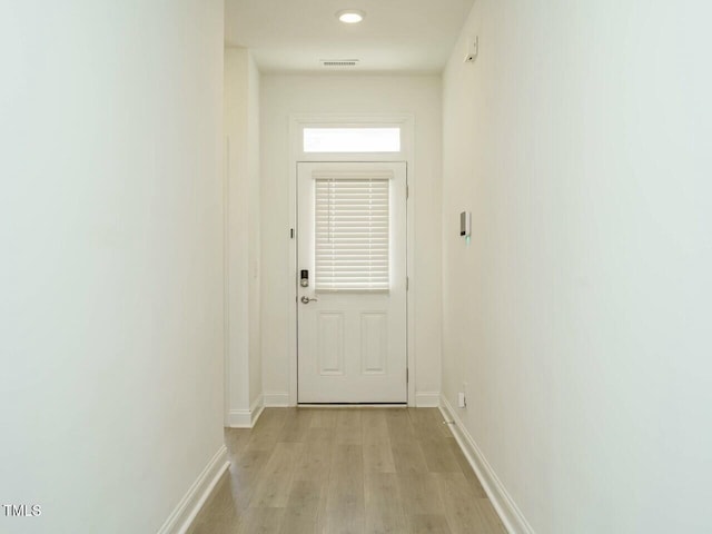 entryway with visible vents, light wood-style flooring, and baseboards