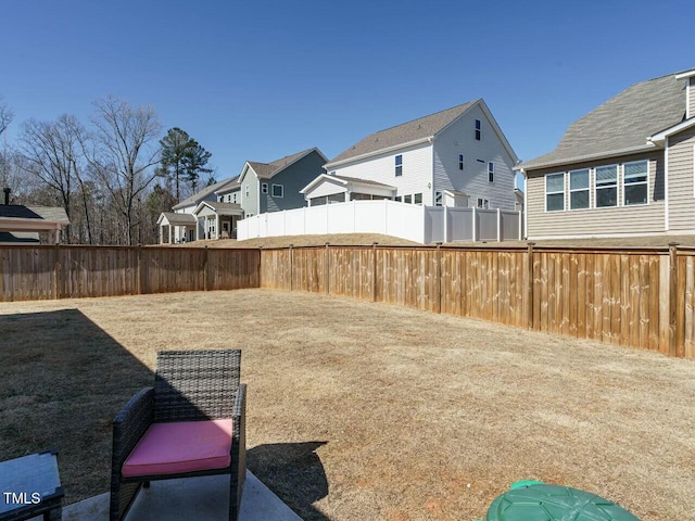 view of yard featuring fence and a residential view