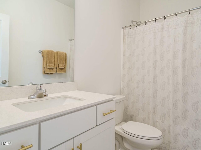 full bath featuring toilet, a shower with shower curtain, and vanity