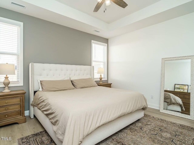 bedroom featuring light wood-style floors, baseboards, and visible vents