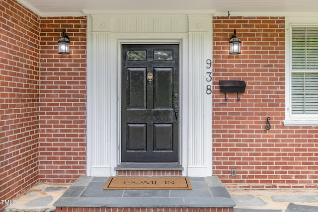 entrance to property with brick siding