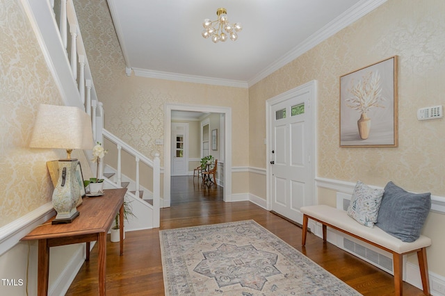 foyer featuring wallpapered walls, stairway, a notable chandelier, and wood finished floors