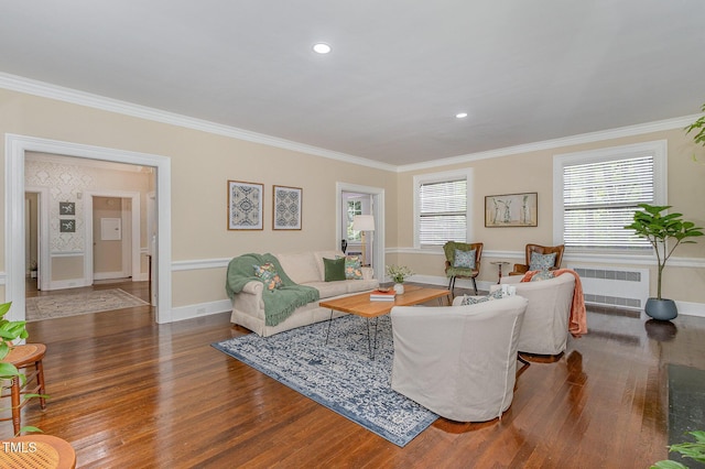 living room with radiator, baseboards, wood finished floors, and ornamental molding