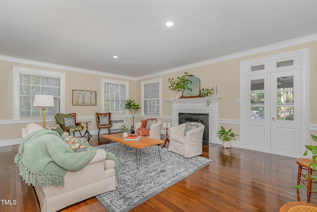 living area with a healthy amount of sunlight, crown molding, and wood finished floors