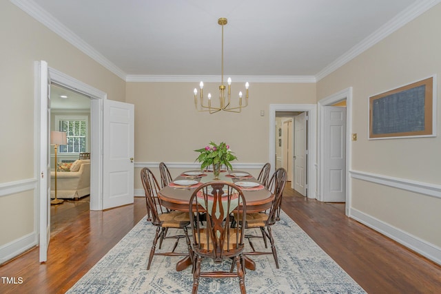 dining space featuring dark wood-style floors, baseboards, a chandelier, and crown molding