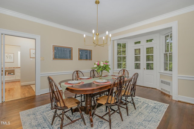 dining space with crown molding, baseboards, radiator heating unit, dark wood finished floors, and an inviting chandelier