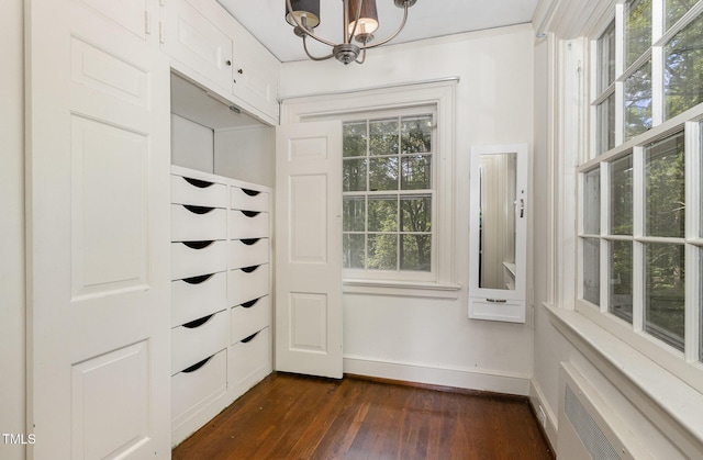 interior space featuring dark wood-style floors and a chandelier