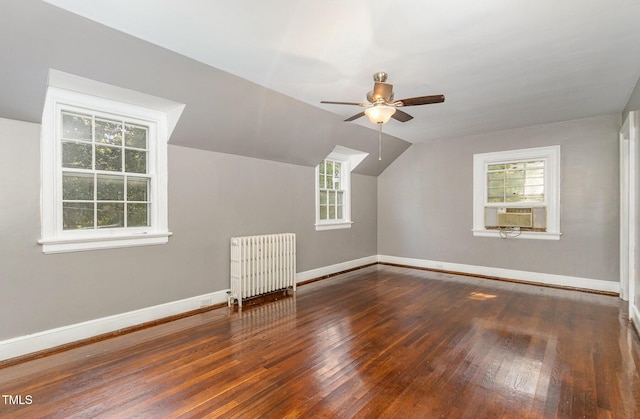 bonus room featuring radiator, wood-type flooring, vaulted ceiling, cooling unit, and baseboards