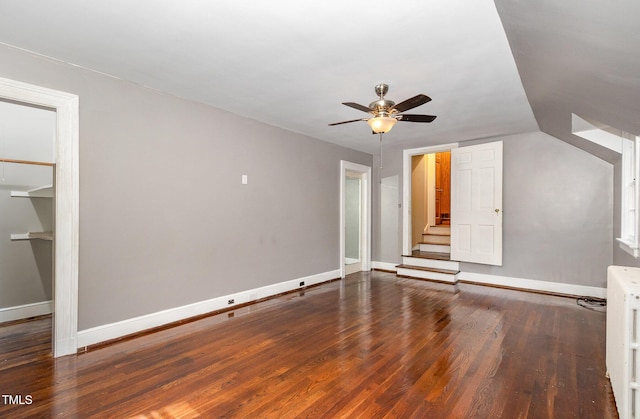 interior space featuring radiator heating unit, baseboards, and wood finished floors