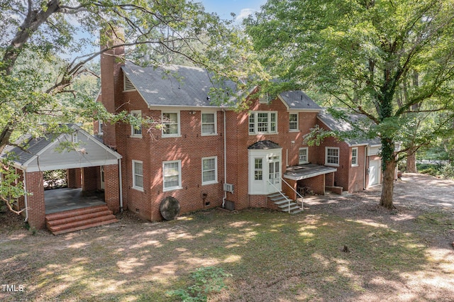 back of property with entry steps, a chimney, crawl space, central air condition unit, and brick siding