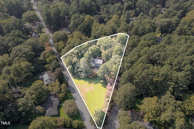 drone / aerial view featuring a wooded view