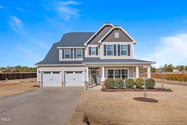 craftsman inspired home with a garage, a shingled roof, fence, concrete driveway, and board and batten siding