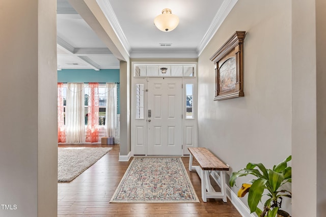 foyer entrance featuring hardwood / wood-style flooring, visible vents, baseboards, beamed ceiling, and crown molding