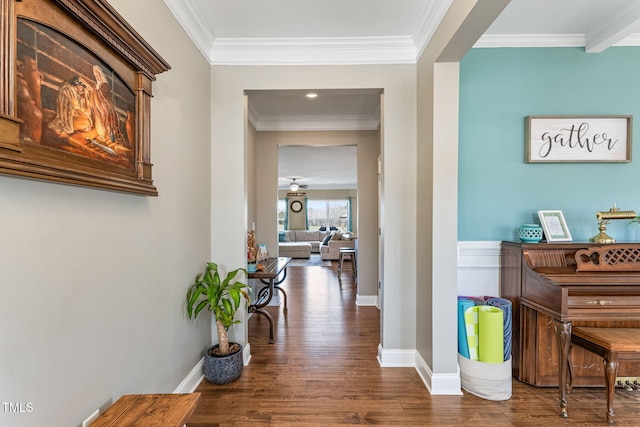 hall with crown molding, baseboards, and wood finished floors