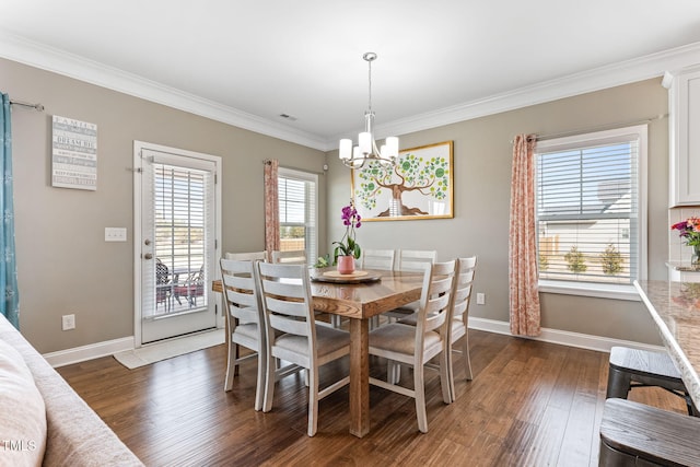 dining space with dark wood-type flooring, visible vents, baseboards, ornamental molding, and an inviting chandelier