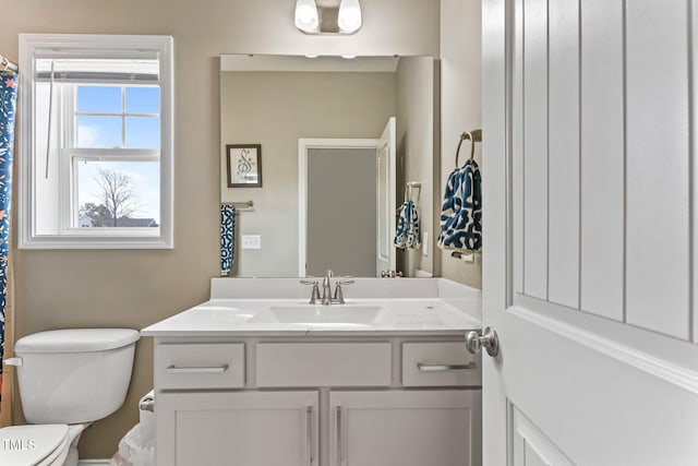 full bathroom with toilet and vanity