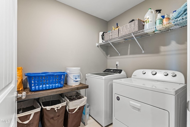 clothes washing area featuring laundry area and separate washer and dryer