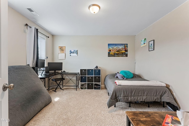 carpeted bedroom featuring visible vents