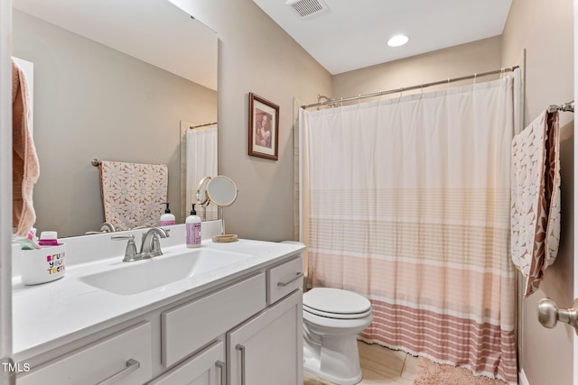 bathroom with toilet, visible vents, a shower with shower curtain, and vanity