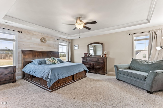 bedroom with ceiling fan, carpet flooring, visible vents, baseboards, and a raised ceiling