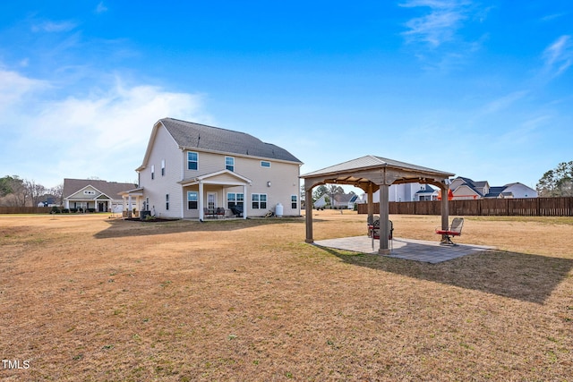 back of property with a patio area, a yard, fence, and a gazebo