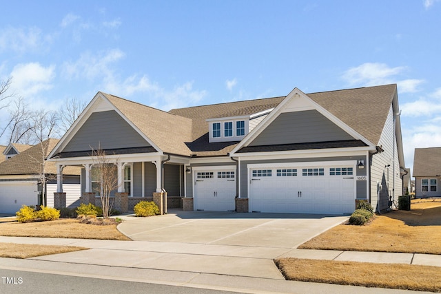 view of front of house featuring a porch, concrete driveway, brick siding, and a garage