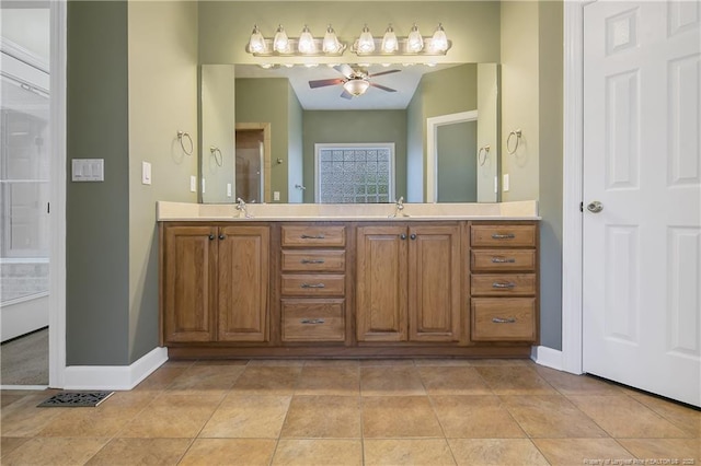 full bath featuring tile patterned flooring, a sink, a ceiling fan, baseboards, and double vanity